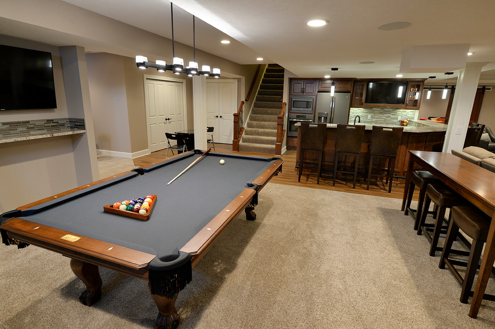 Example of a transitional underground basement design in Cleveland with a stone fireplace