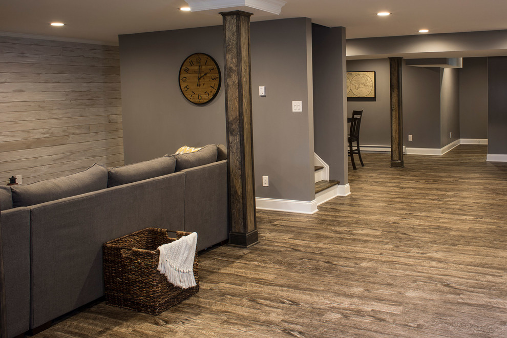 Large mountain style underground medium tone wood floor basement photo in Boston with gray walls and no fireplace