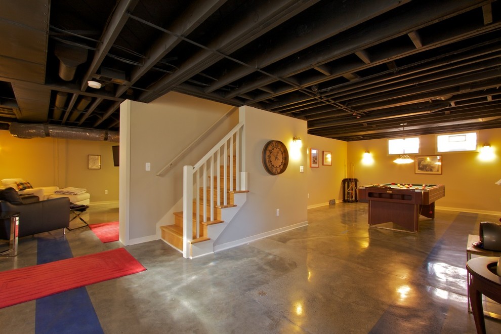 Medium sized traditional fully buried basement in Detroit with beige walls, concrete flooring and multi-coloured floors.