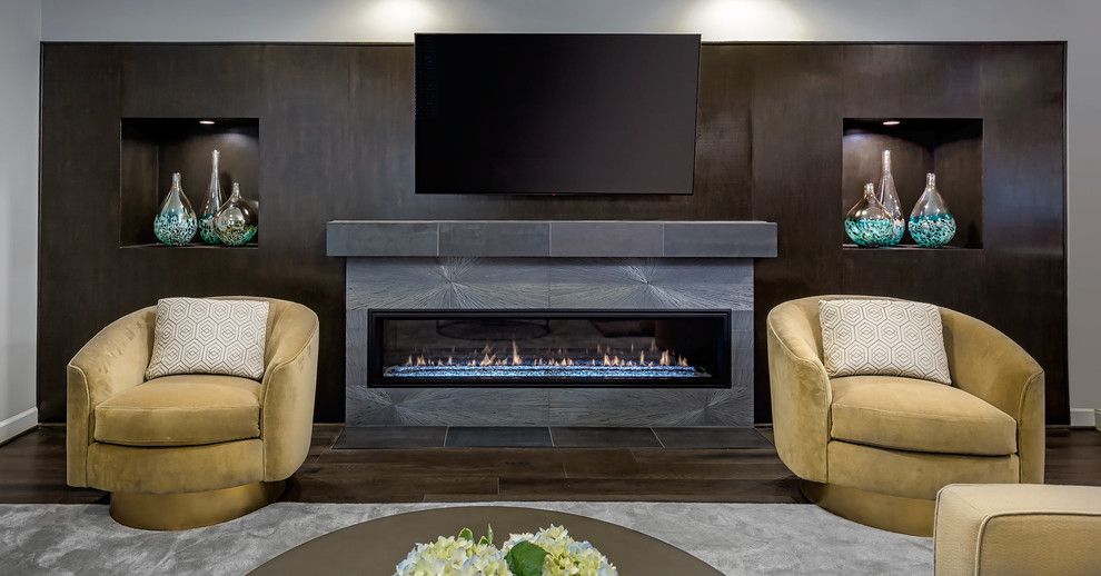 Photo of a medium sized contemporary look-out basement in DC Metro with grey walls, dark hardwood flooring, a ribbon fireplace, a concrete fireplace surround and brown floors.