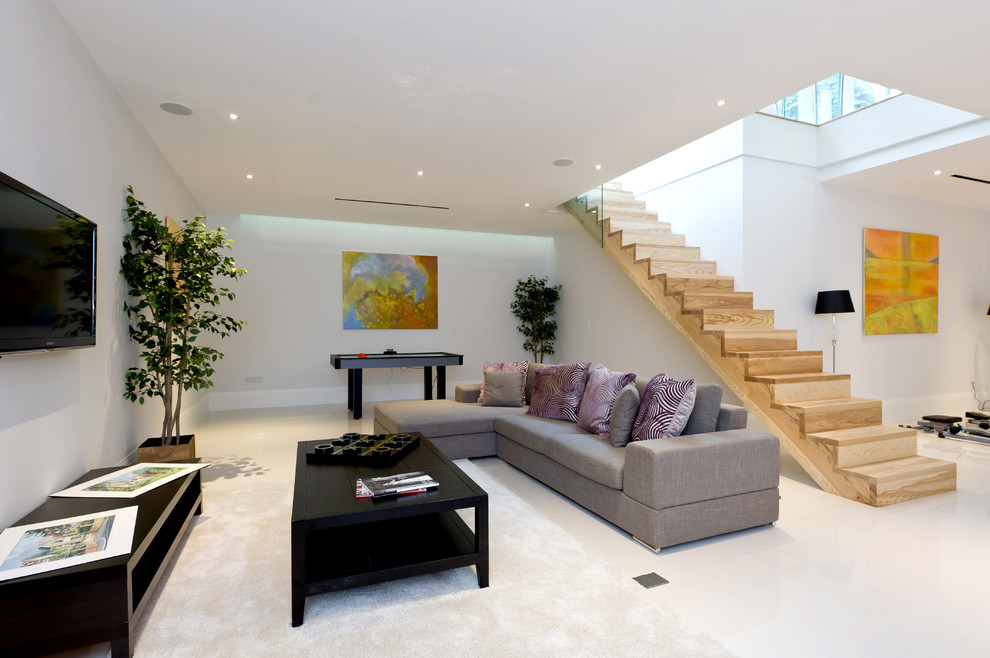 Идея дизайна: гостиная комната в современном стиле с белыми стенами, телевизором на стене и белым полом