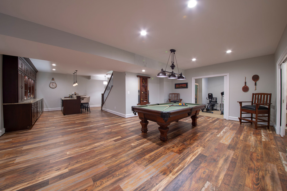 Basement - huge traditional walk-out medium tone wood floor and brown floor basement idea in DC Metro with gray walls and no fireplace
