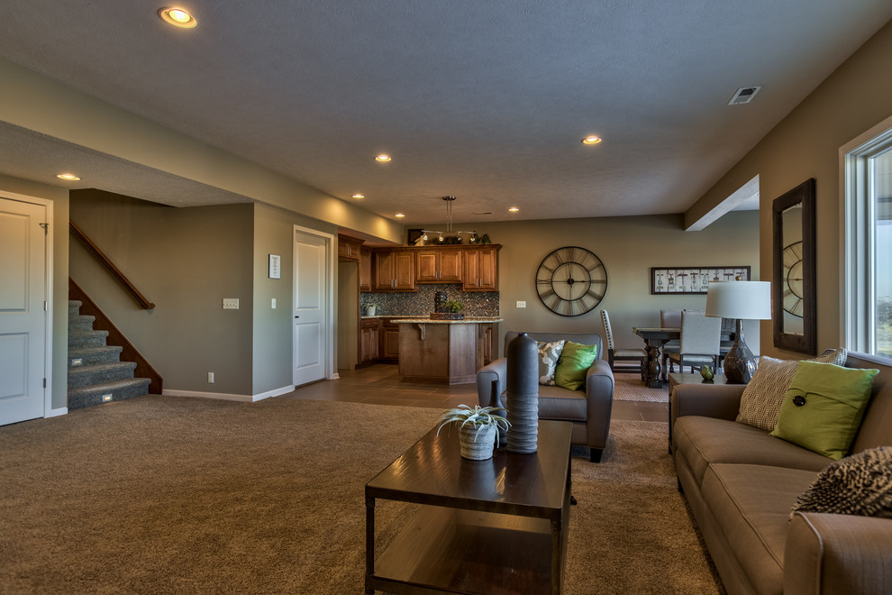 This is an example of a large modern walk-out basement in Omaha with carpet and no fireplace.