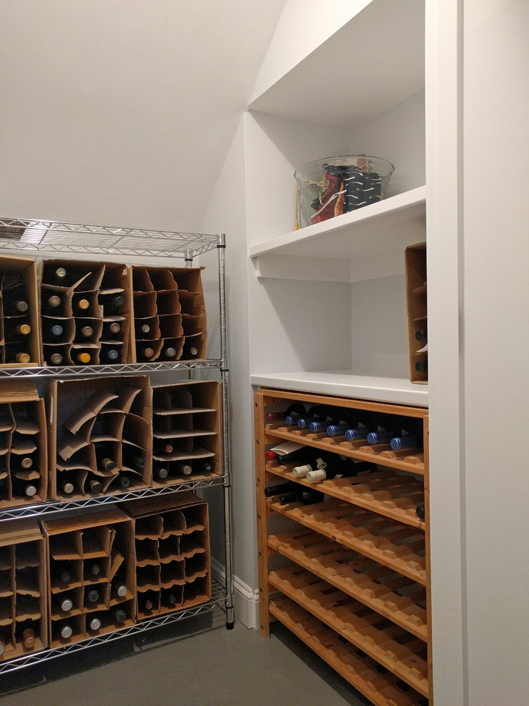 Example of a small trendy carpeted and gray floor wine cellar design in Boston