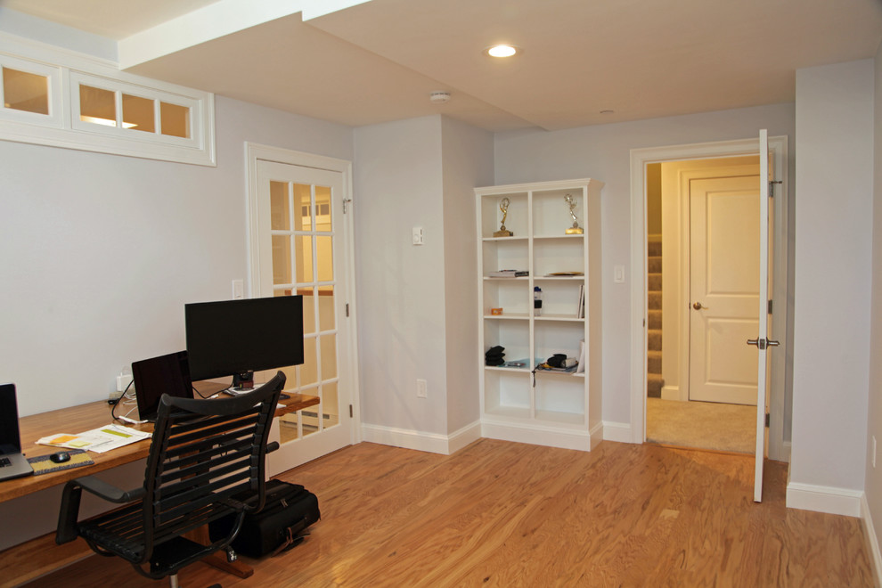 Example of a small trendy underground carpeted and gray floor basement design in Boston with gray walls