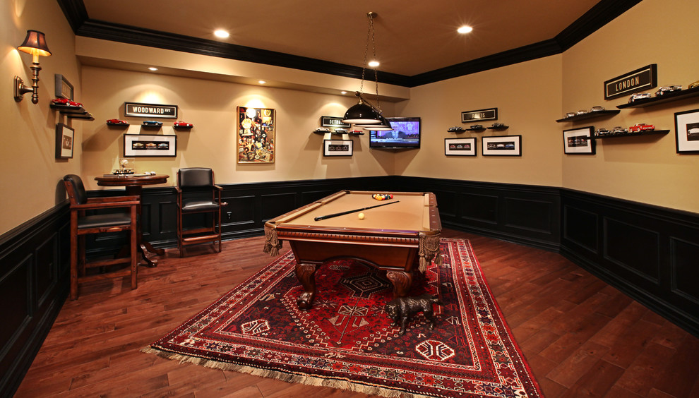 Example of a large classic medium tone wood floor basement design in Detroit with beige walls