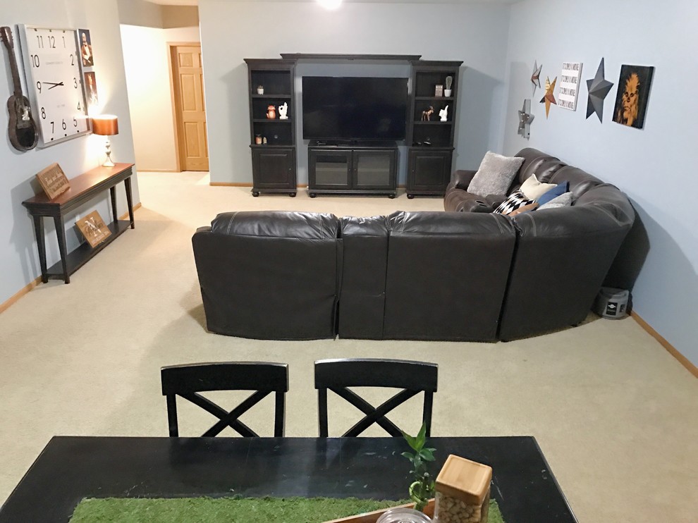 Example of a large transitional underground carpeted and beige floor basement design in Omaha with blue walls and no fireplace