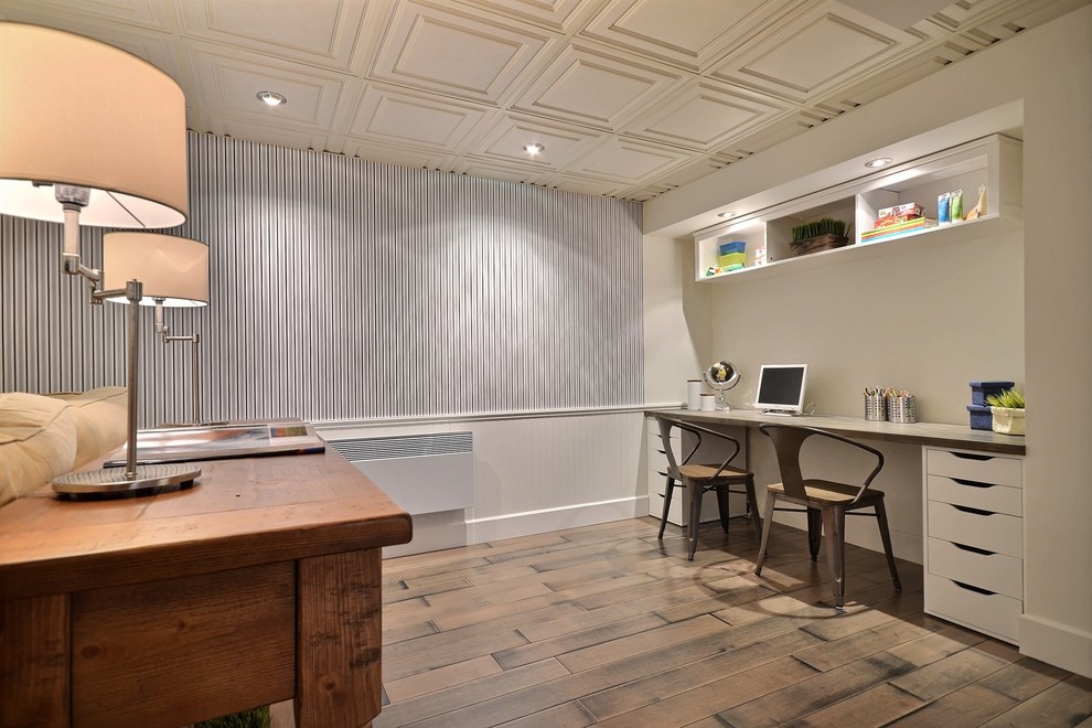 Classic home office in Montreal with blue walls, dark hardwood flooring, no fireplace and beige floors.