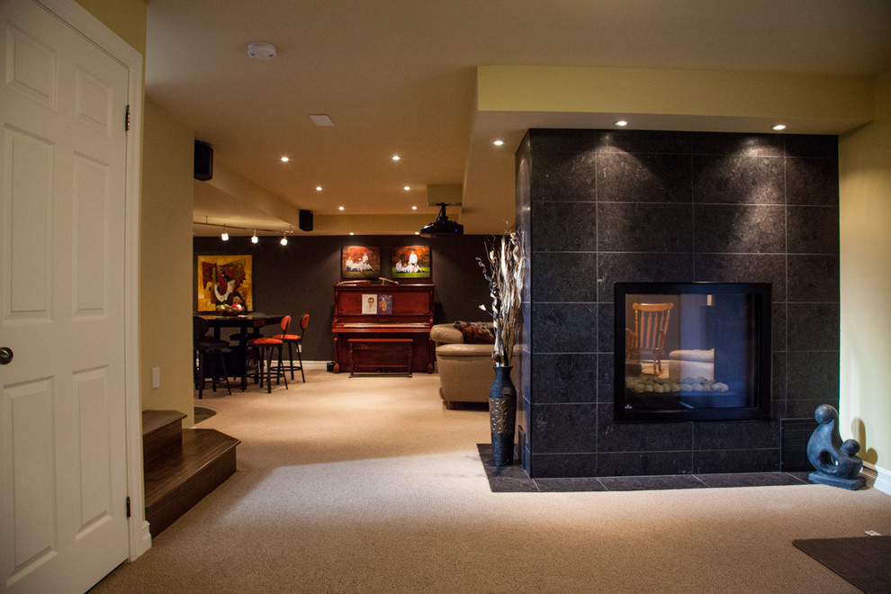 Design ideas for a large contemporary walk-out basement in Toronto with a two-sided fireplace and brown floors.