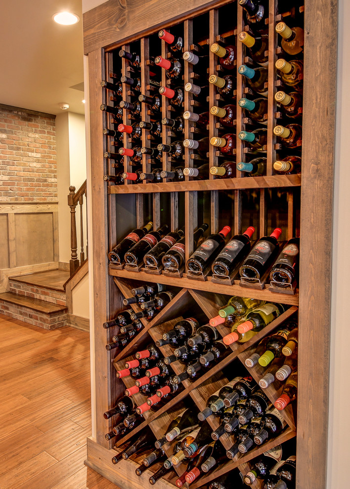 Medium sized traditional wine cellar in Dallas with medium hardwood flooring and brown floors.