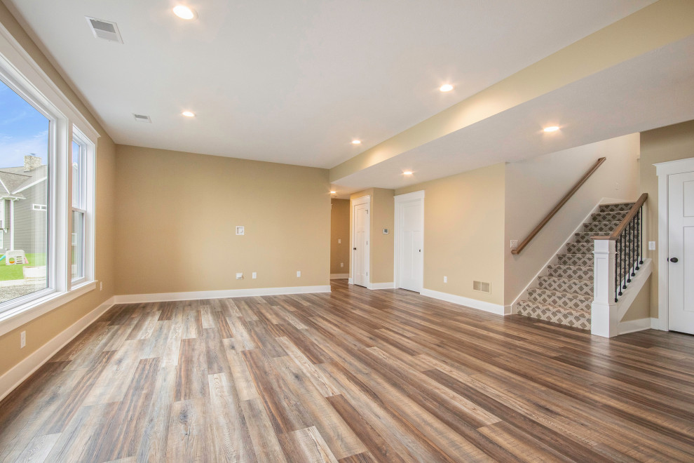 Inspiration for a classic walk-out basement in Grand Rapids with vinyl flooring.