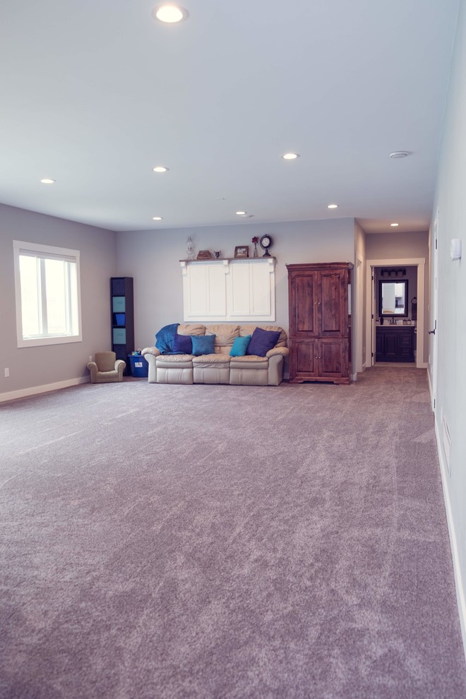 Classic walk-out basement in Cedar Rapids with grey walls, carpet and no fireplace.