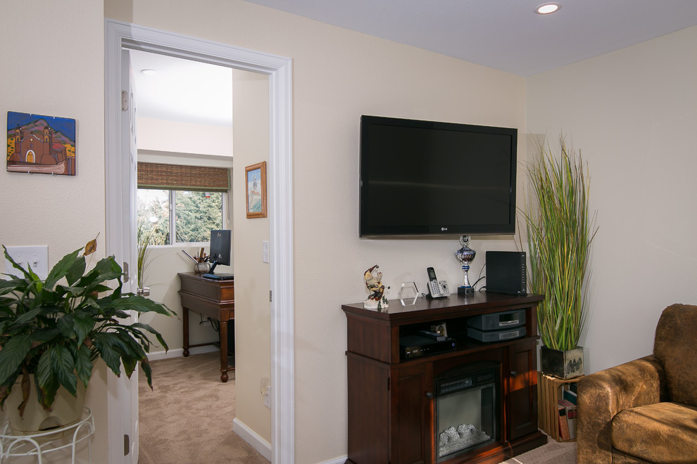 Example of a small classic look-out carpeted basement design in Denver with beige walls
