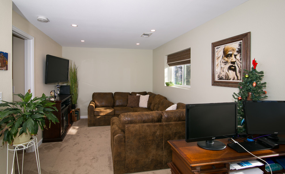 This is an example of a small traditional look-out basement in Denver with beige walls and carpet.