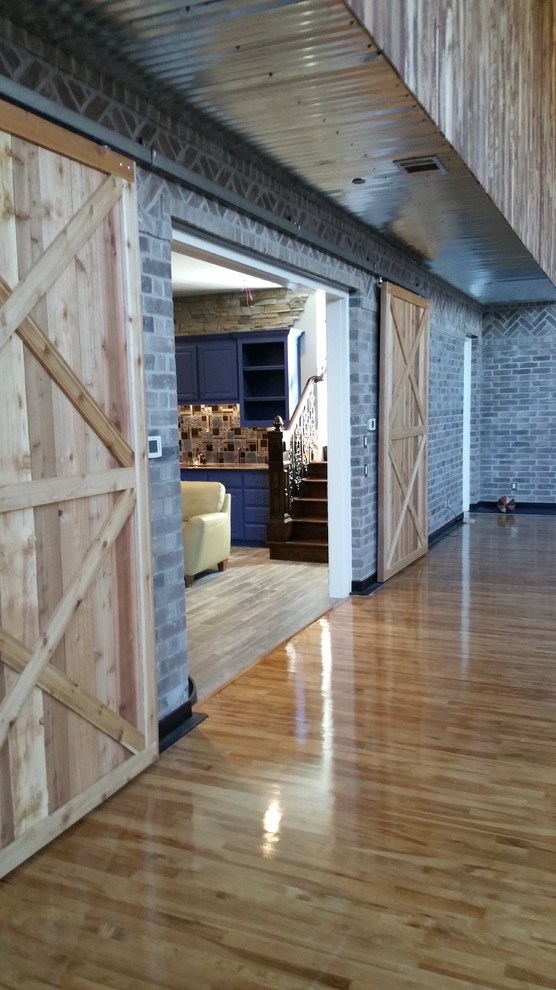Example of a huge classic walk-out light wood floor basement design in Dallas with gray walls and no fireplace