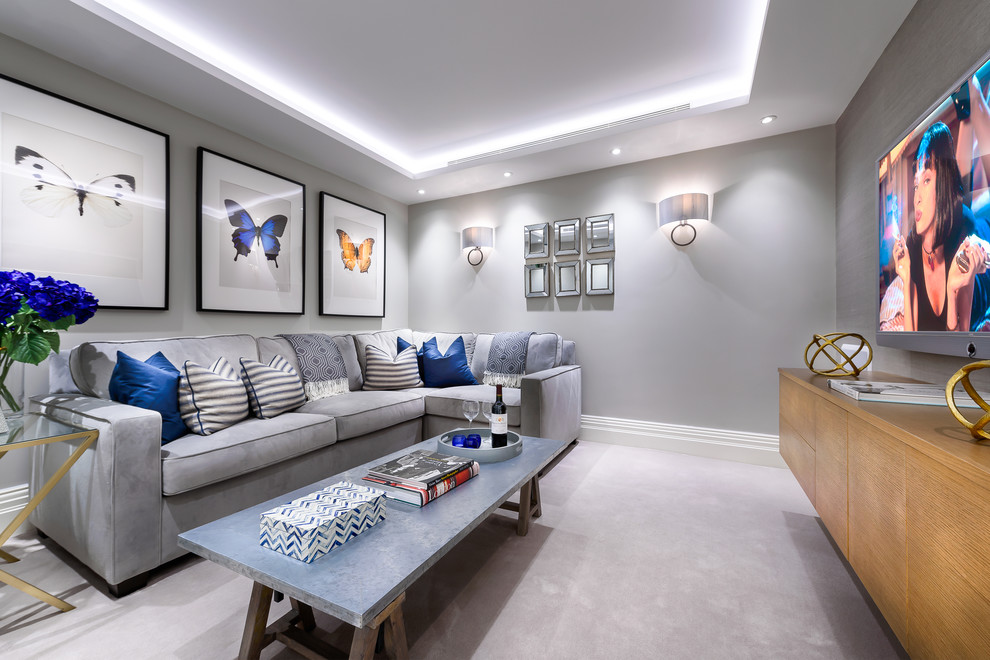 Family room - transitional carpeted and gray floor family room idea in London with gray walls