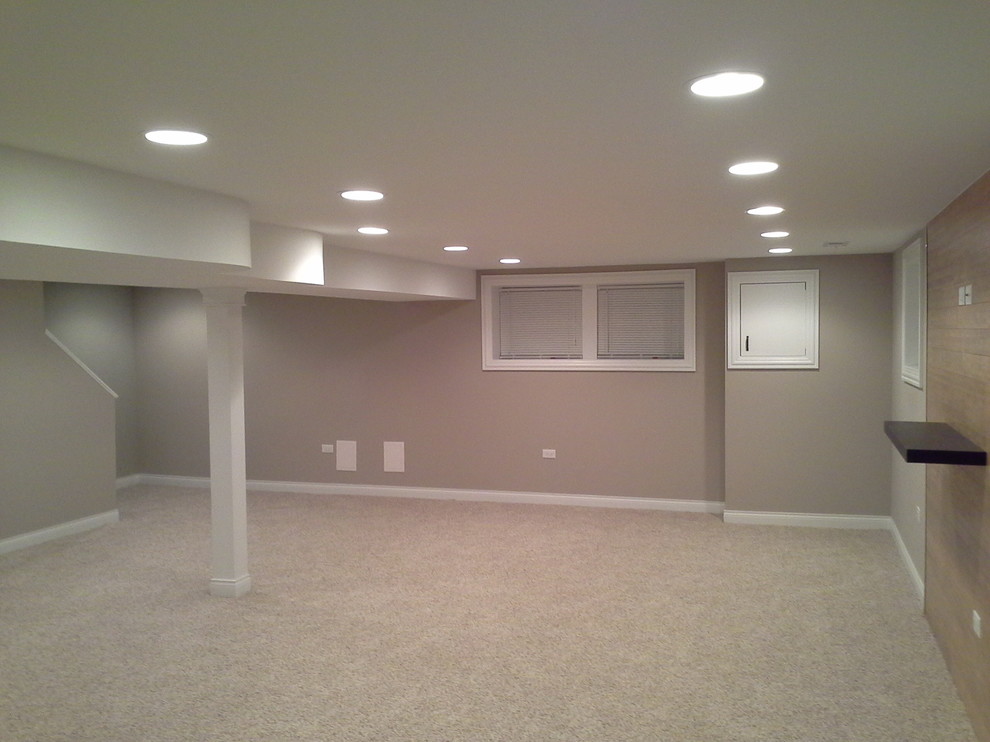 Design ideas for a large classic look-out basement in Chicago with beige walls and carpet.