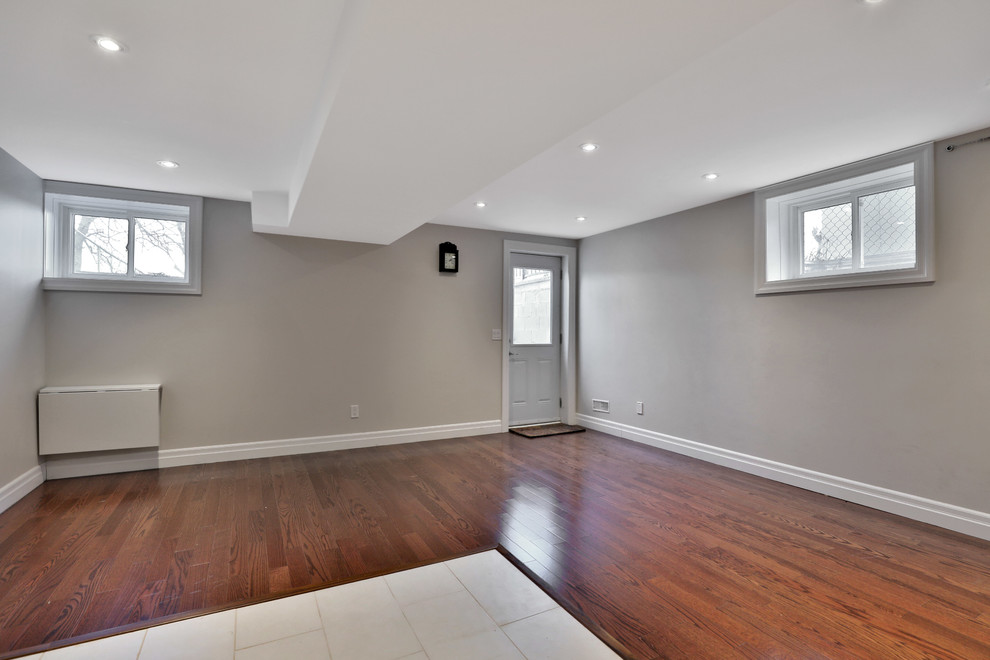 Mid-sized minimalist walk-out basement photo with gray walls