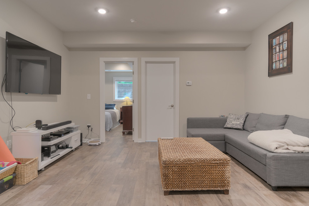 Example of a small minimalist walk-out vinyl floor and brown floor basement design in Other with gray walls