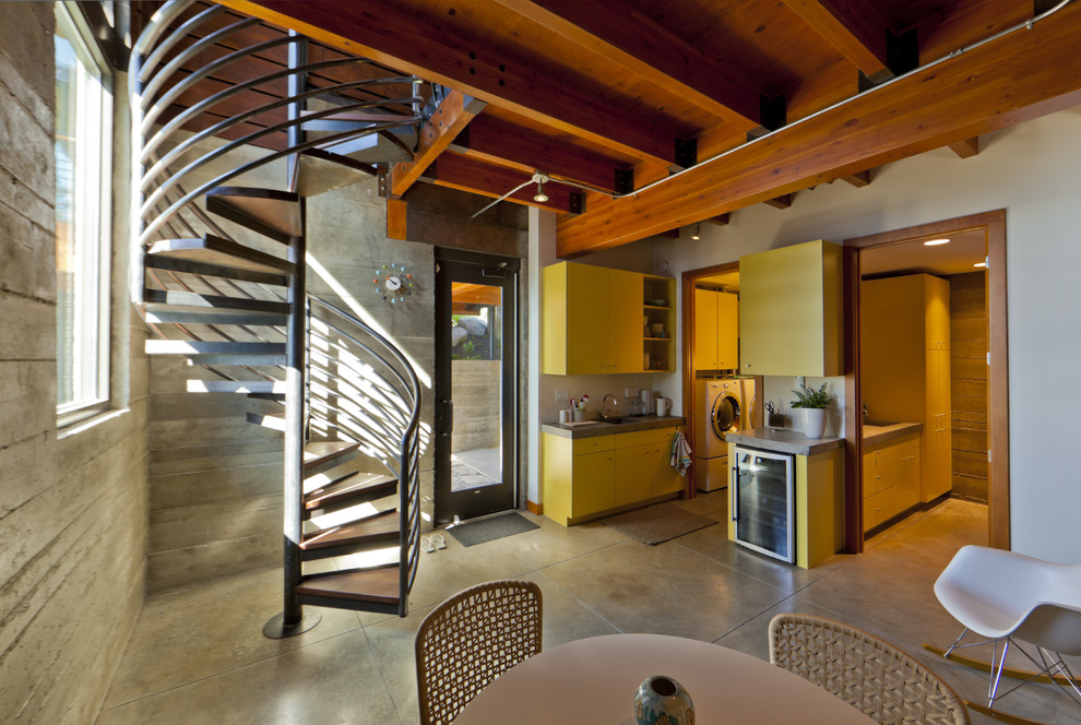 Inspiration for an industrial walk-out basement in Seattle with concrete flooring and no fireplace.
