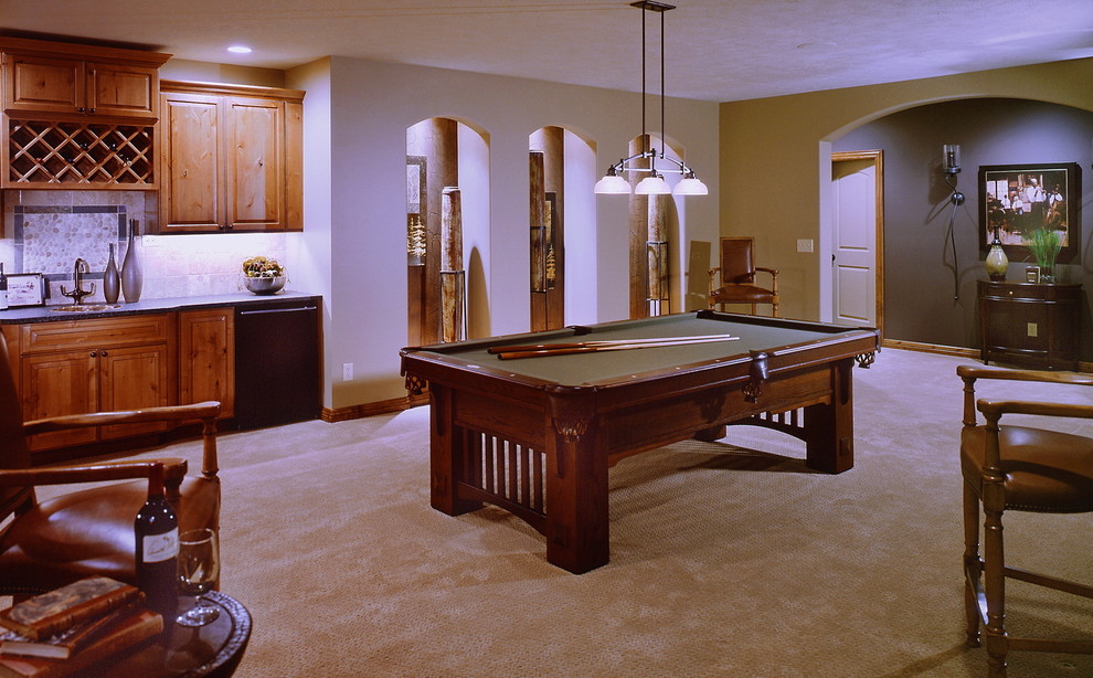 Example of a large classic walk-out carpeted and beige floor basement game room design in Omaha with beige walls, no fireplace and a tile fireplace