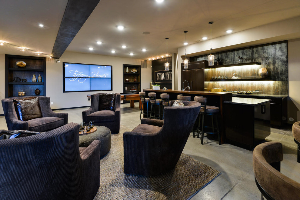Example of a huge trendy underground concrete floor and gray floor basement design in Denver with gray walls and no fireplace