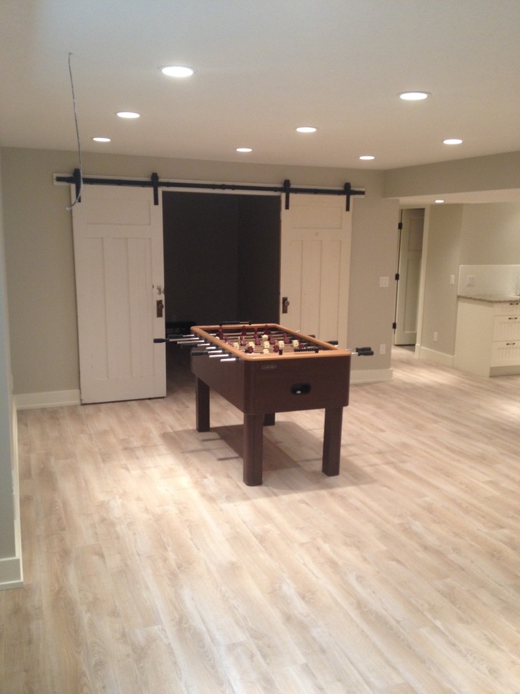 Basement - mid-sized transitional underground light wood floor and beige floor basement idea in Calgary with beige walls