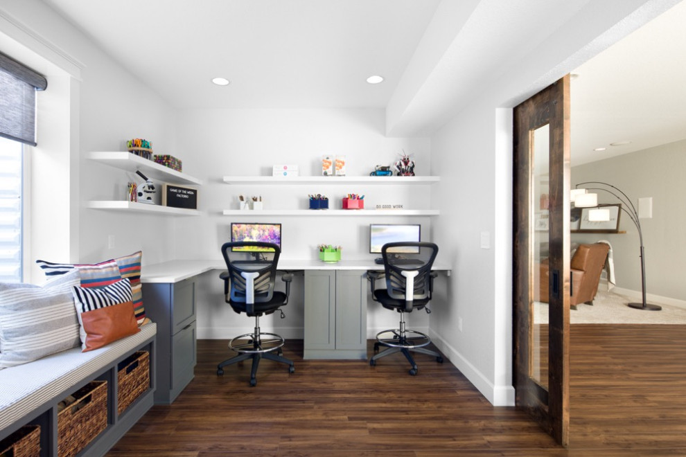 This is an example of a large contemporary look-out basement in Denver with white walls, medium hardwood flooring, no fireplace and brown floors.