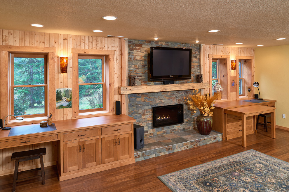 This is an example of a large rustic walk-out basement in Other with yellow walls, bamboo flooring, a ribbon fireplace and a stone fireplace surround.