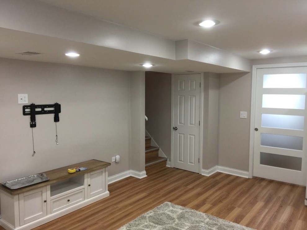 Design ideas for a small classic fully buried basement in Chicago with grey walls, light hardwood flooring and brown floors.
