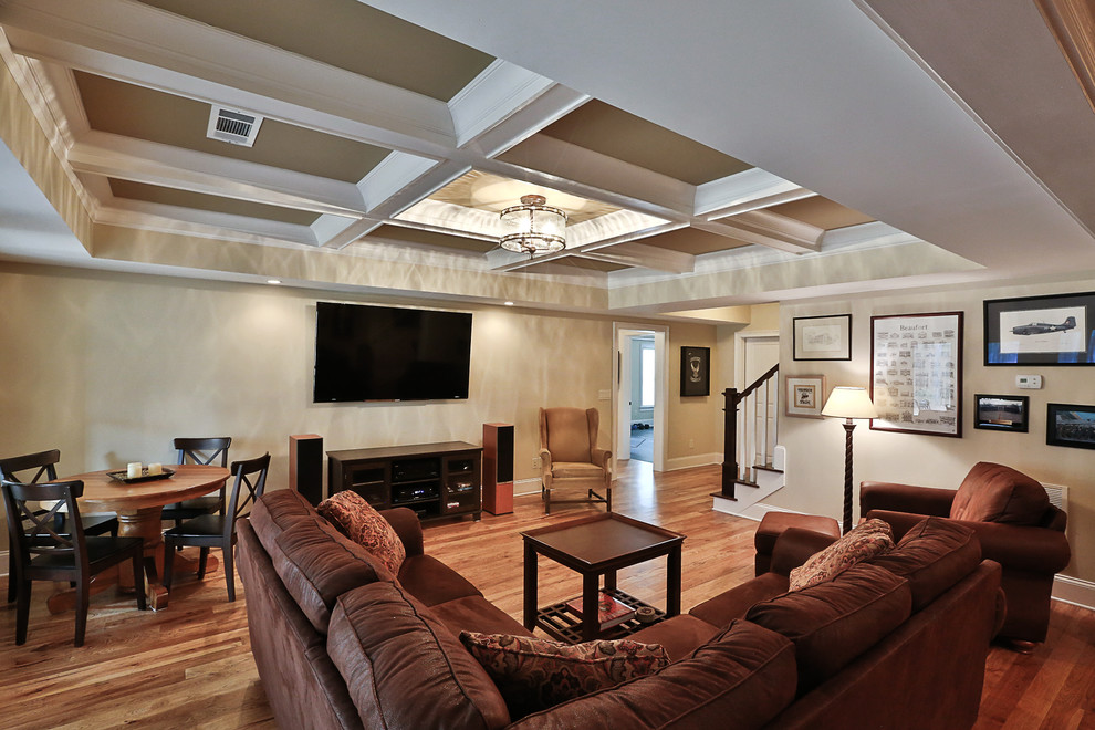 Photo of a large classic walk-out basement in Atlanta with beige walls, medium hardwood flooring and no fireplace.