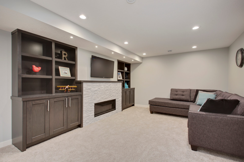 Inspiration for a mid-sized transitional underground carpeted basement remodel in Calgary with gray walls, a standard fireplace and a stone fireplace