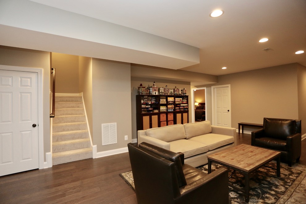 Large contemporary fully buried basement in DC Metro with brown walls, dark hardwood flooring, a ribbon fireplace, a stone fireplace surround and brown floors.
