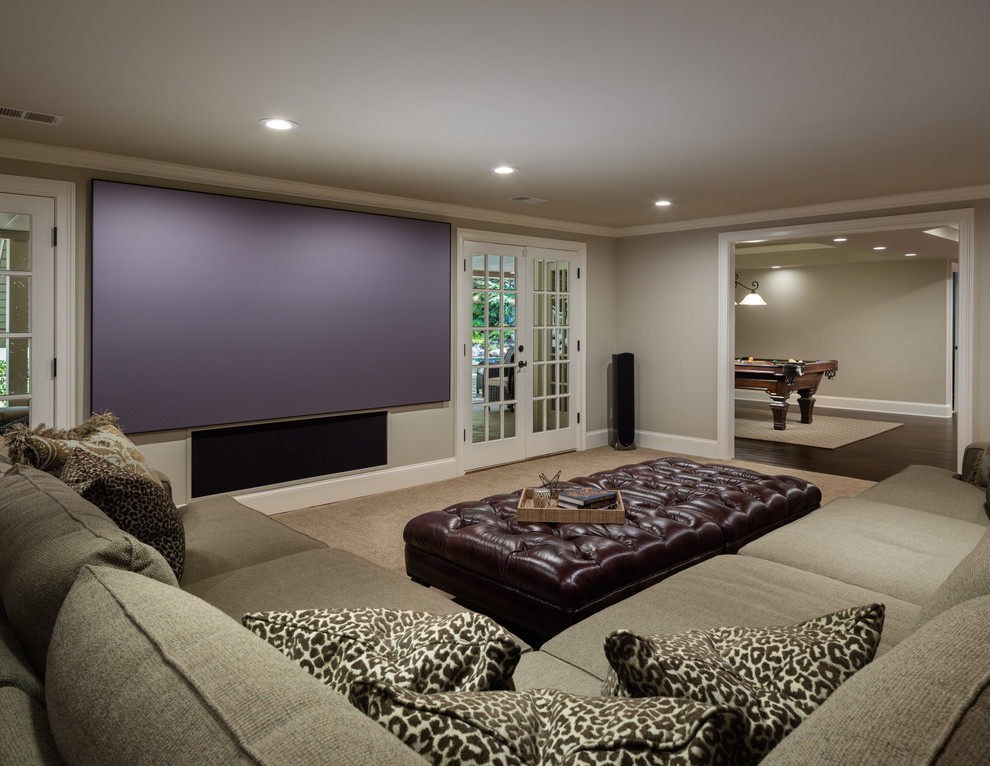 Basement - large traditional walk-out carpeted and brown floor basement idea in Atlanta with beige walls, no fireplace and a home theater