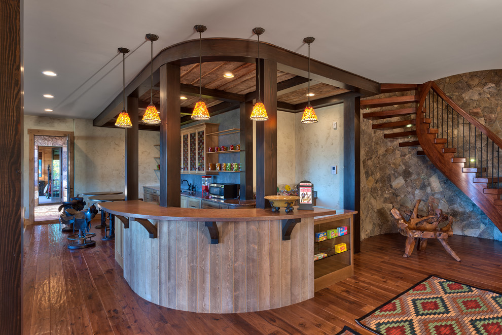 Inspiration for a rustic home bar in Other with dark hardwood flooring.