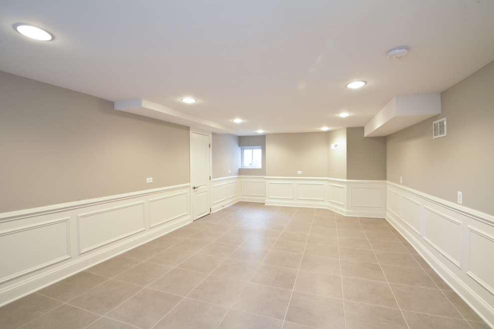 Medium sized look-out basement in Chicago with beige walls and ceramic flooring.