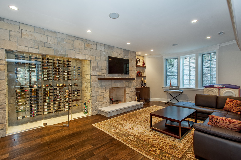 Basement - transitional look-out dark wood floor basement idea in Chicago with a stone fireplace, a standard fireplace and white walls