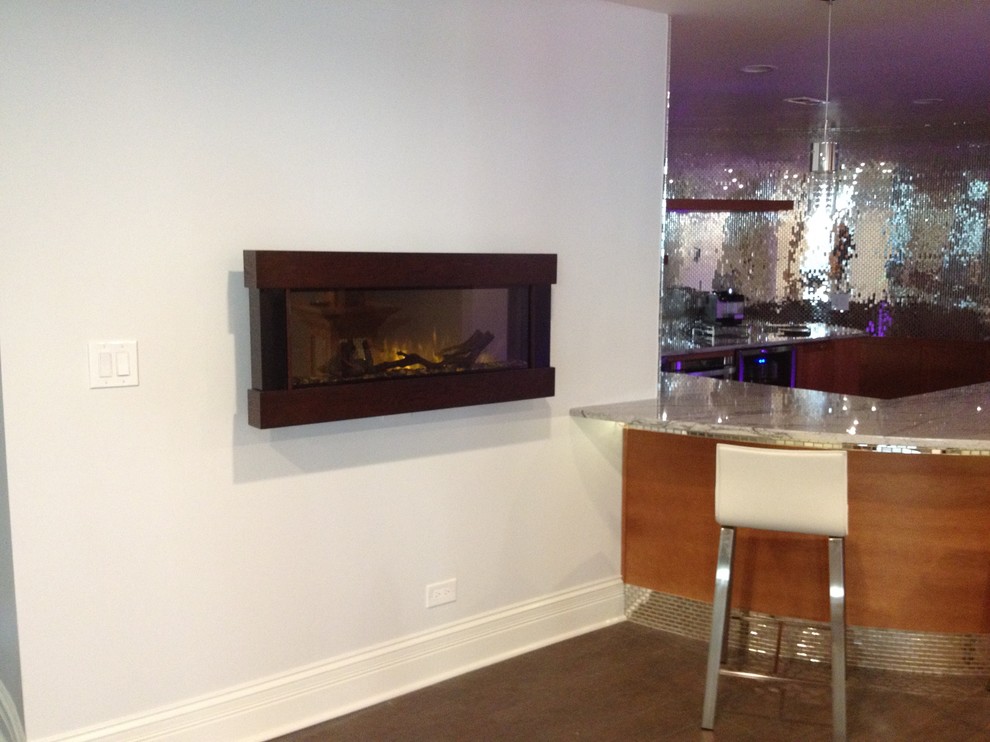 Example of a large trendy underground ceramic tile and gray floor basement design in Chicago with gray walls, a hanging fireplace and a metal fireplace