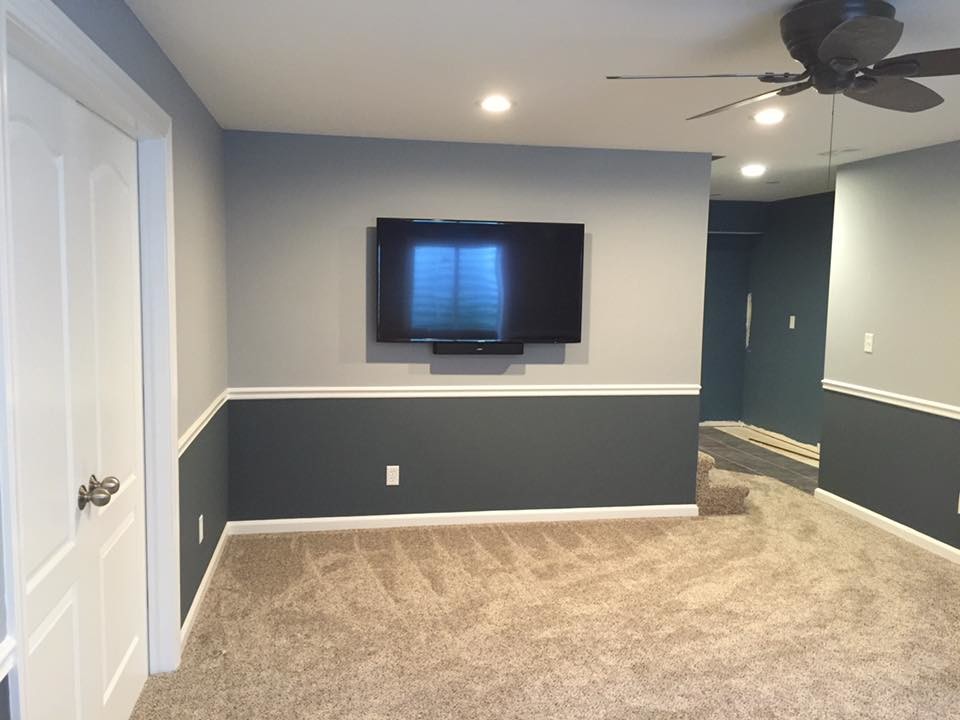 Example of a small transitional underground carpeted and brown floor basement design in Chicago with gray walls and no fireplace