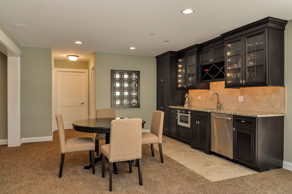 This is an example of a large classic walk-out basement in Nashville with green walls and carpet.