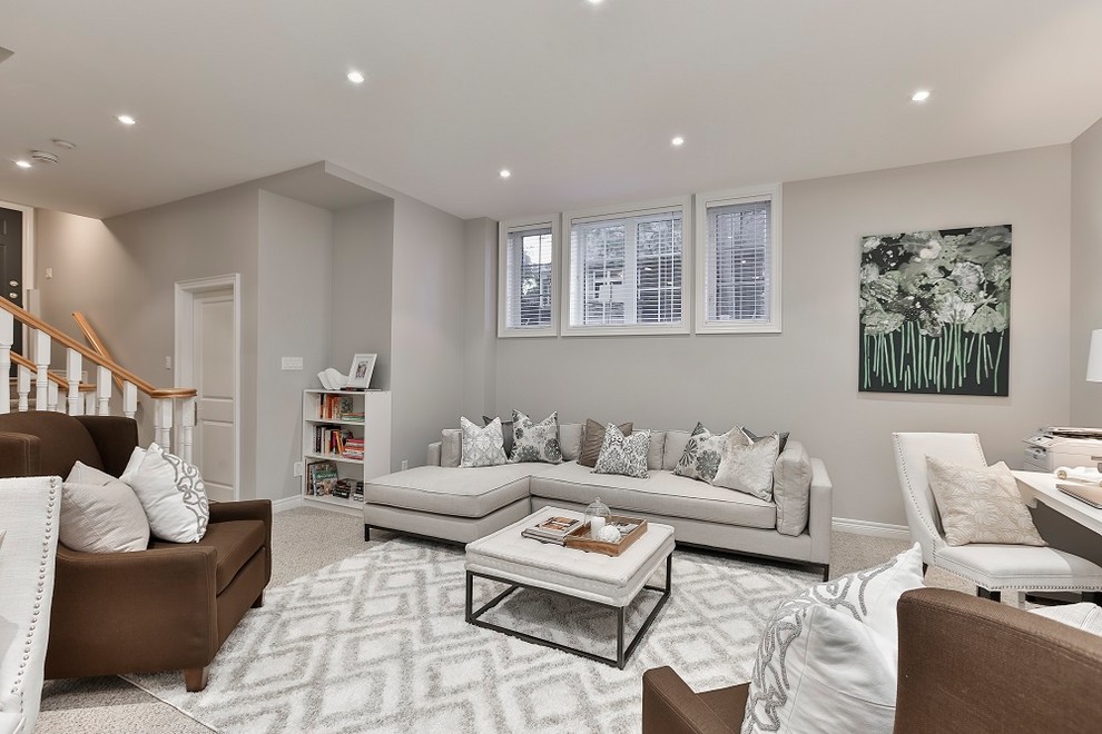 Large classic walk-out basement in Toronto with grey walls, carpet, no fireplace and grey floors.