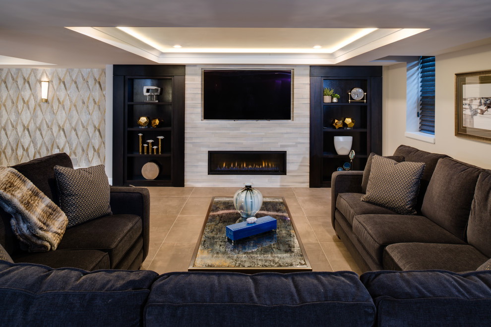 Photo of a medium sized contemporary look-out basement in Detroit with beige walls, porcelain flooring, a ribbon fireplace, a stone fireplace surround and beige floors.