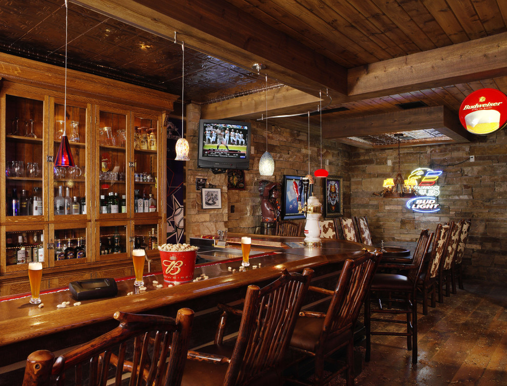Inspiration for a rustic home bar in Denver with dark hardwood flooring.