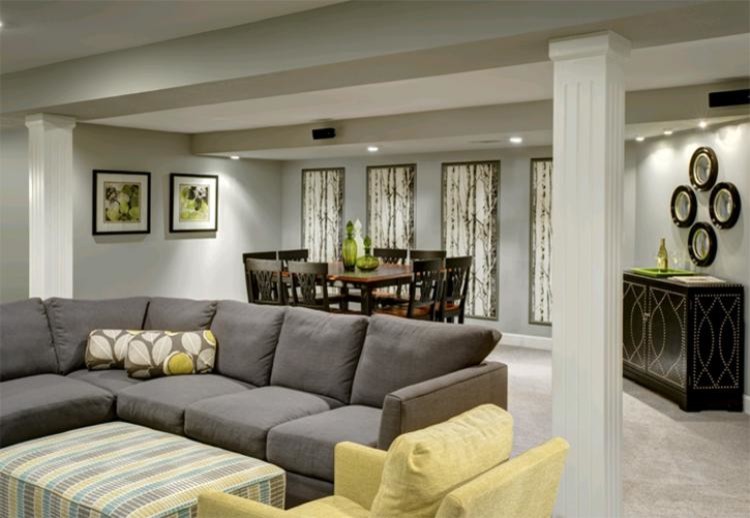 This is an example of a large contemporary fully buried basement in Kansas City with grey walls, carpet, no fireplace and grey floors.