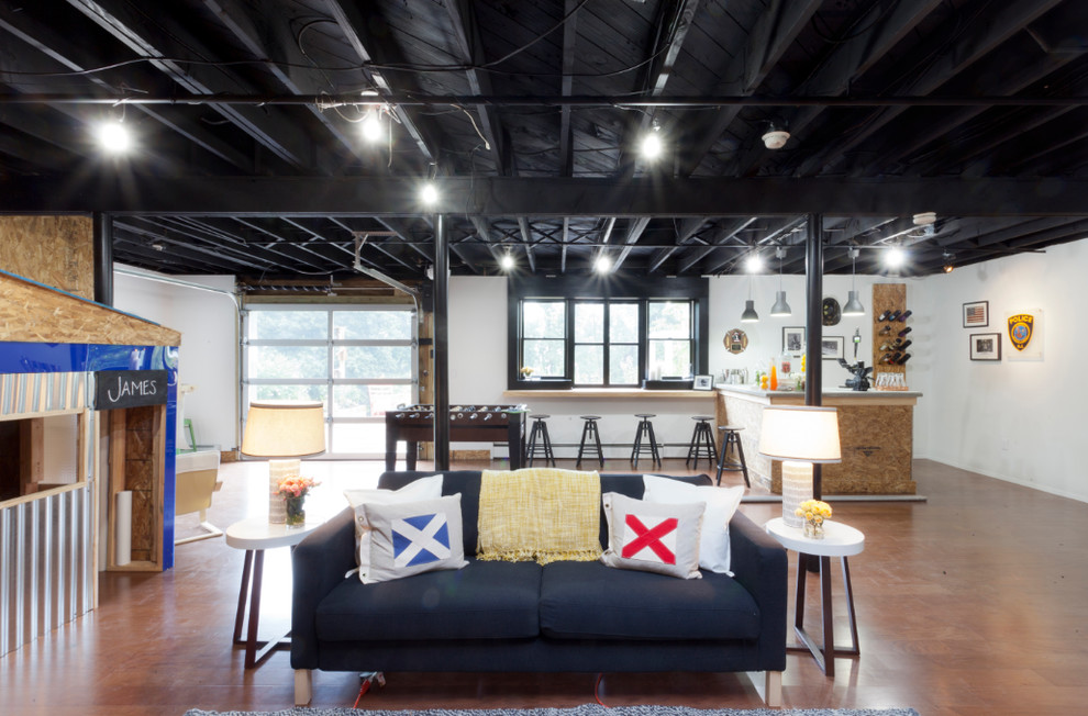 Example of an urban walk-out brown floor basement design in New York with white walls