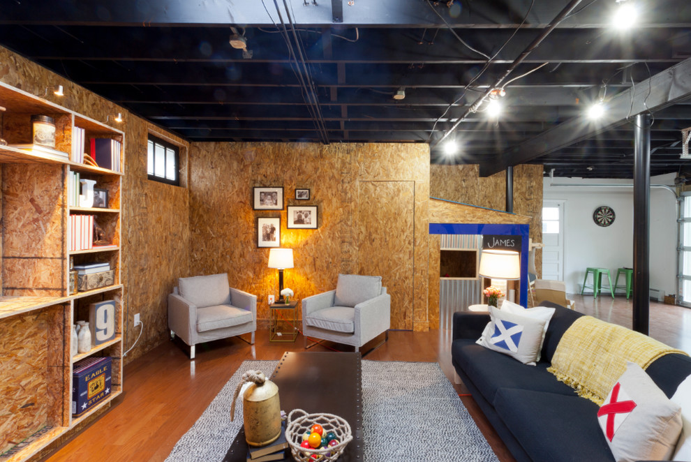 Basement - industrial walk-out medium tone wood floor and orange floor basement idea in New York with no fireplace