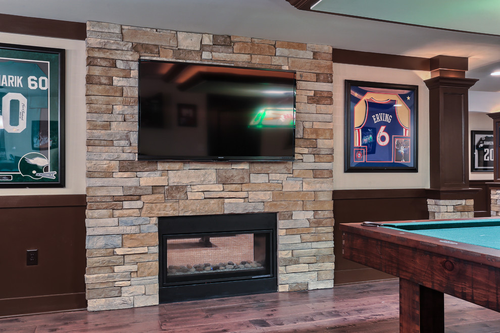 Photo of an expansive classic games room in Other with beige walls, carpet and a stone fireplace surround.