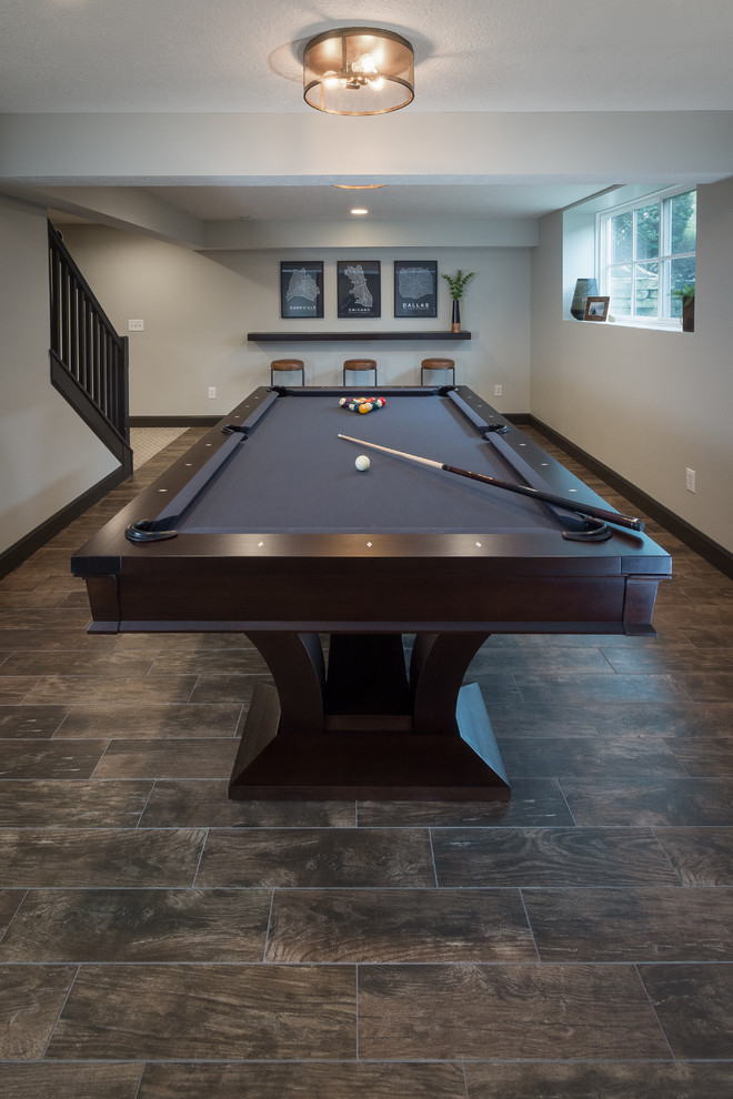 Medium sized classic look-out basement in Columbus with grey walls, porcelain flooring and brown floors.