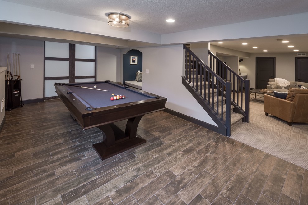 Mid-sized transitional look-out porcelain tile and brown floor basement photo in Columbus with gray walls