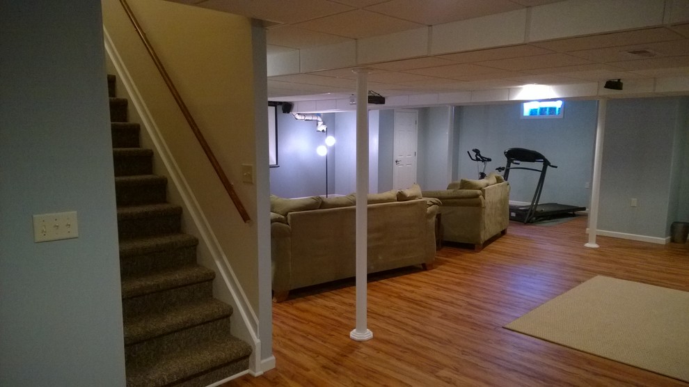 Large contemporary fully buried basement in New York with laminate floors.